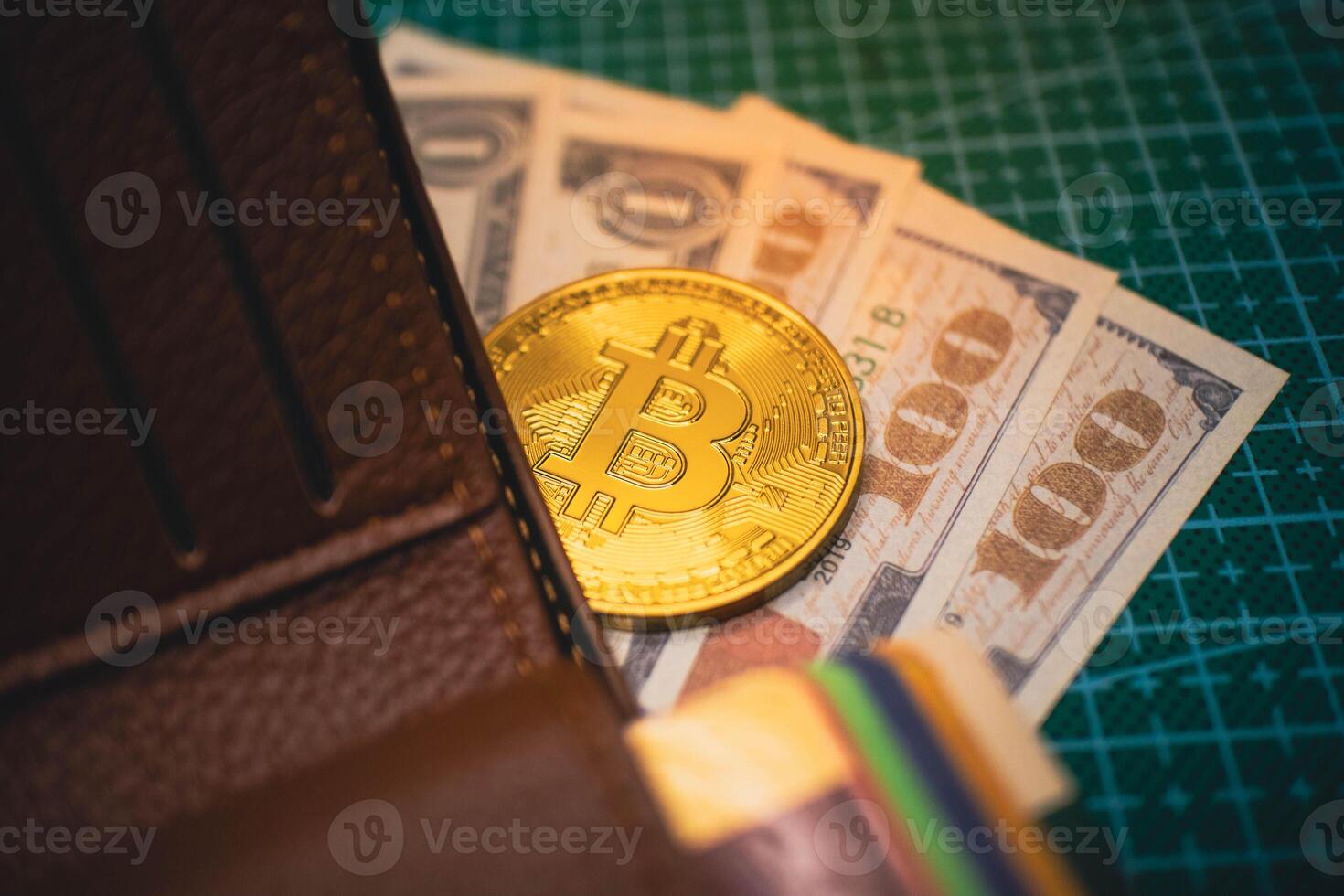 Golden Bitcoin in Brown Wallet with US Dollar Bills, Cryptocurrency Concept. photo