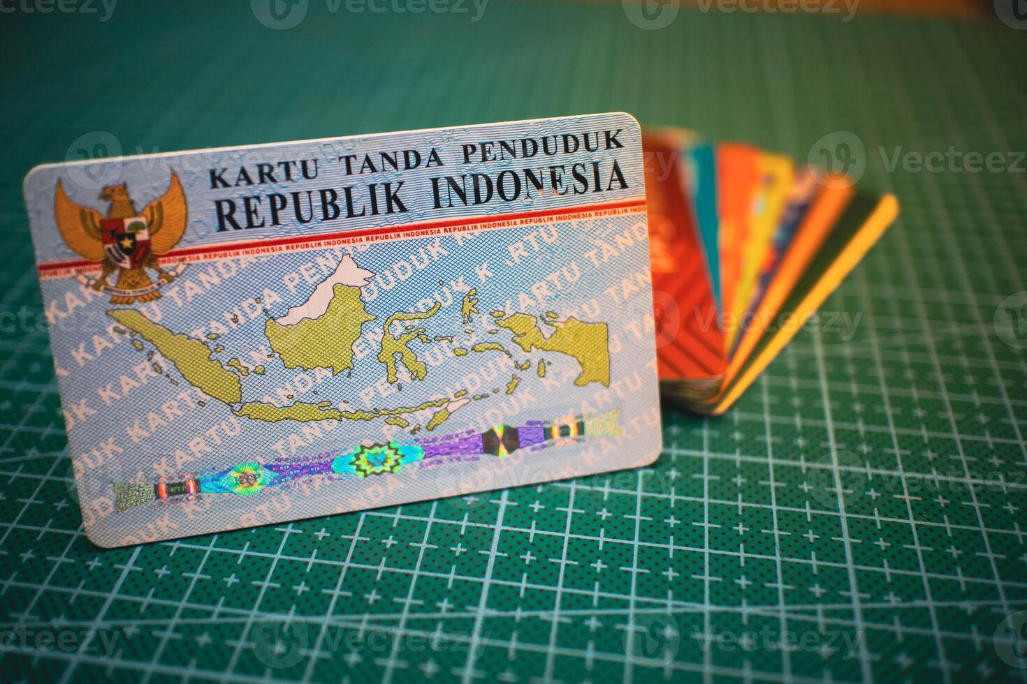 Blue Indonesian ID Card KTP on Green Grid Surface, Identity Document. photo