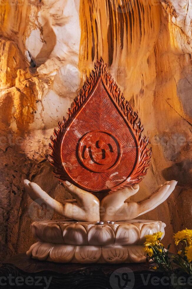 Buddhist statue inside Asian sacred temple in the Am Phu Cave in the Marble Mountains in Da Nang in Vietnam in Asia photo