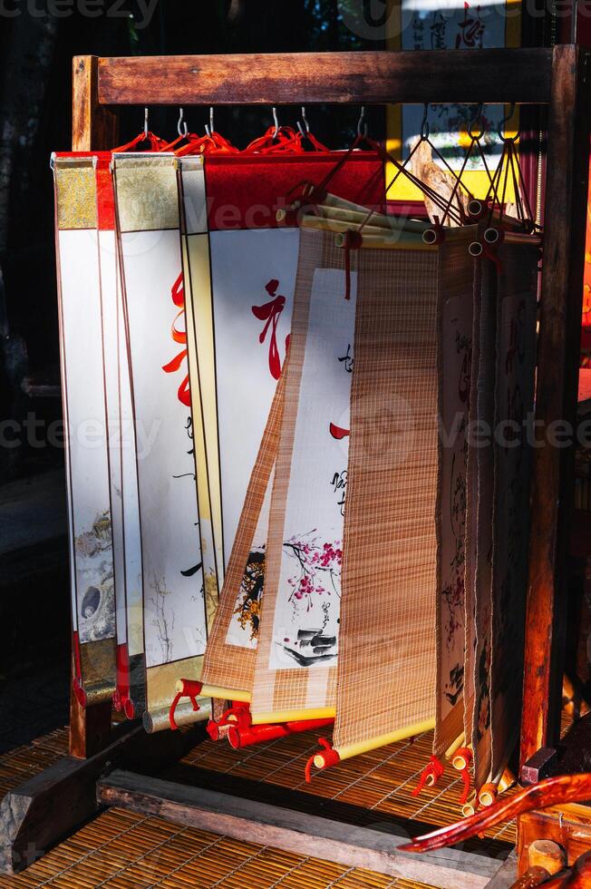Scrolls with manuscripts and hieroglyphs in souvenir shop in Asia photo
