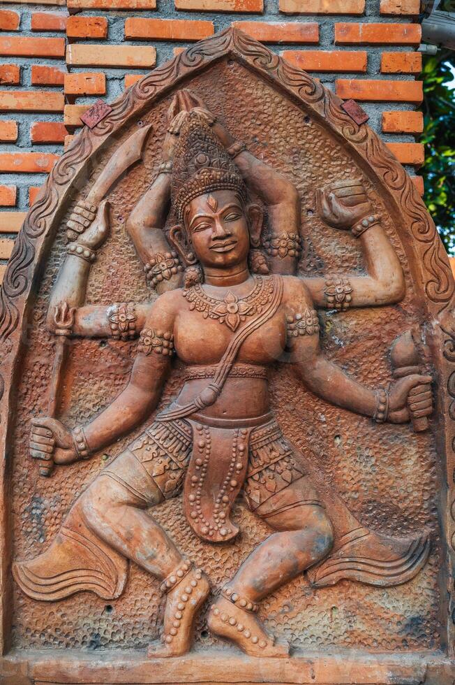 sculpture statue of god Shiva on a Buddhist pagoda in Asia in Vietnam photo