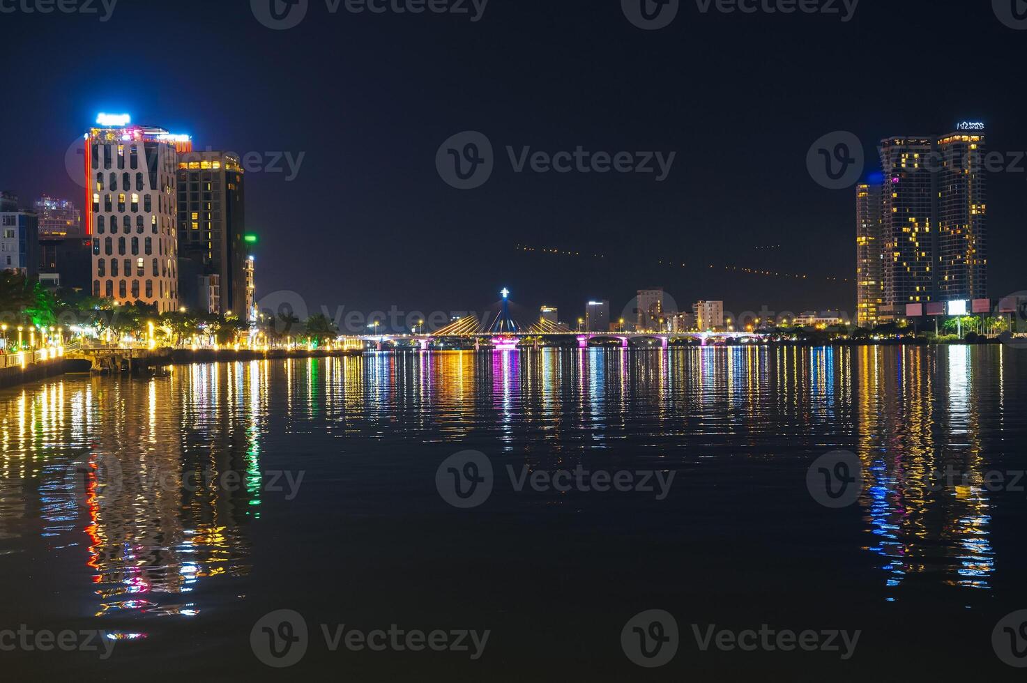 Han River Bridge or Cau Song Han over Han River and skyscrapers in Da Nang in Vietnam at night photo