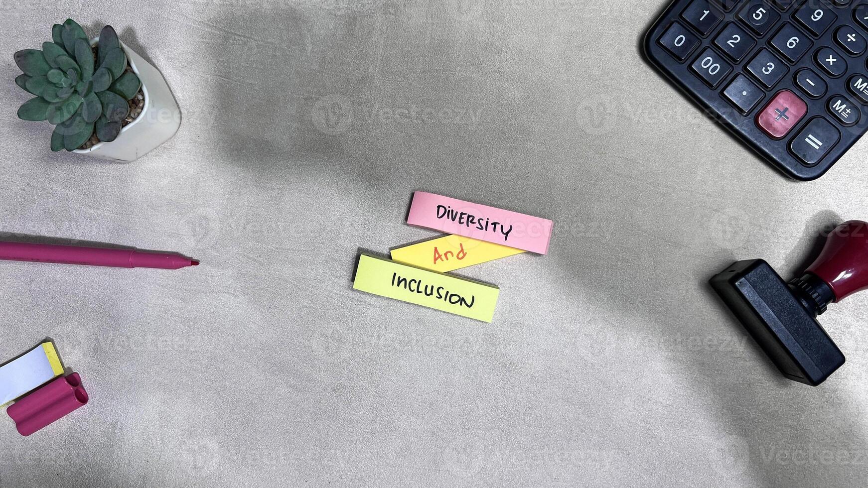Concept of Diversity and Inclusion write on sticky notes isolated on Wooden Table. photo