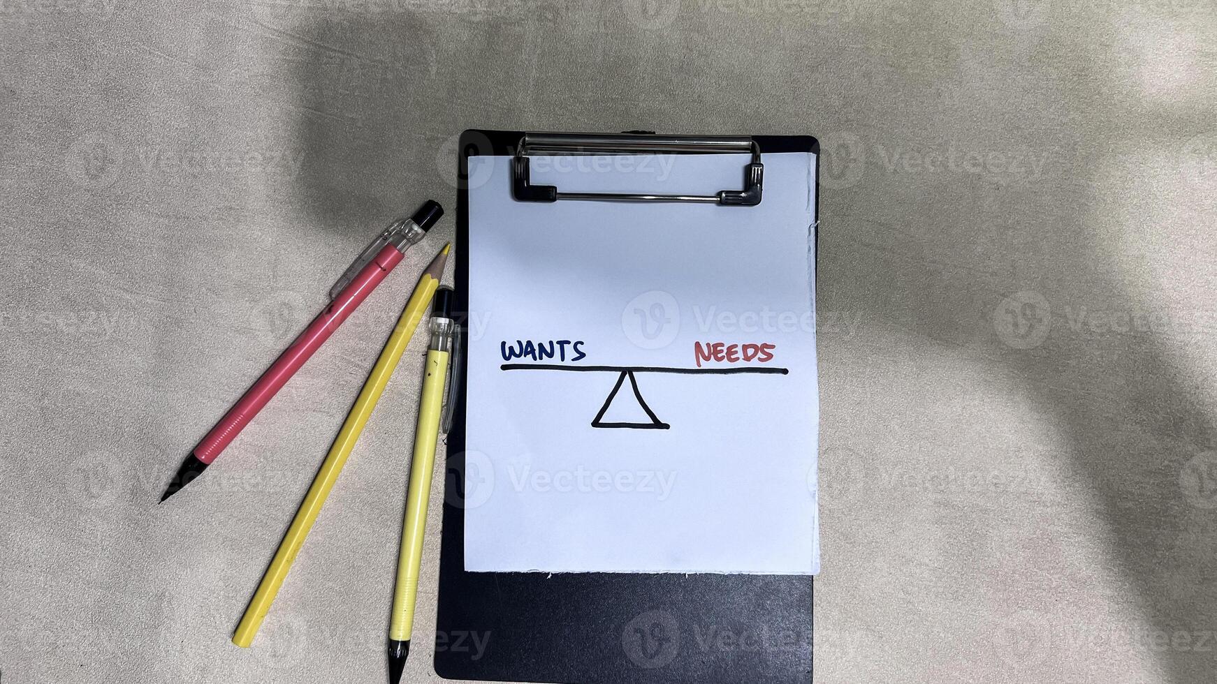 Concept of Wants or Needs write on paperwork isolated on wooden background. photo