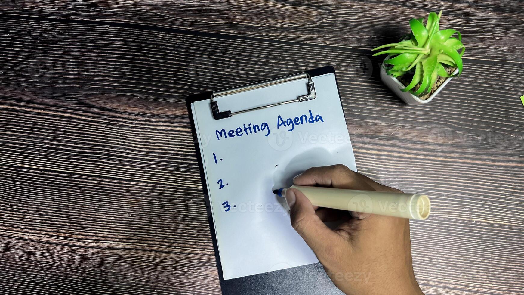 Concept of Meeting Agenda write on paperwork Supported by an additional services isolated on wooden background. photo
