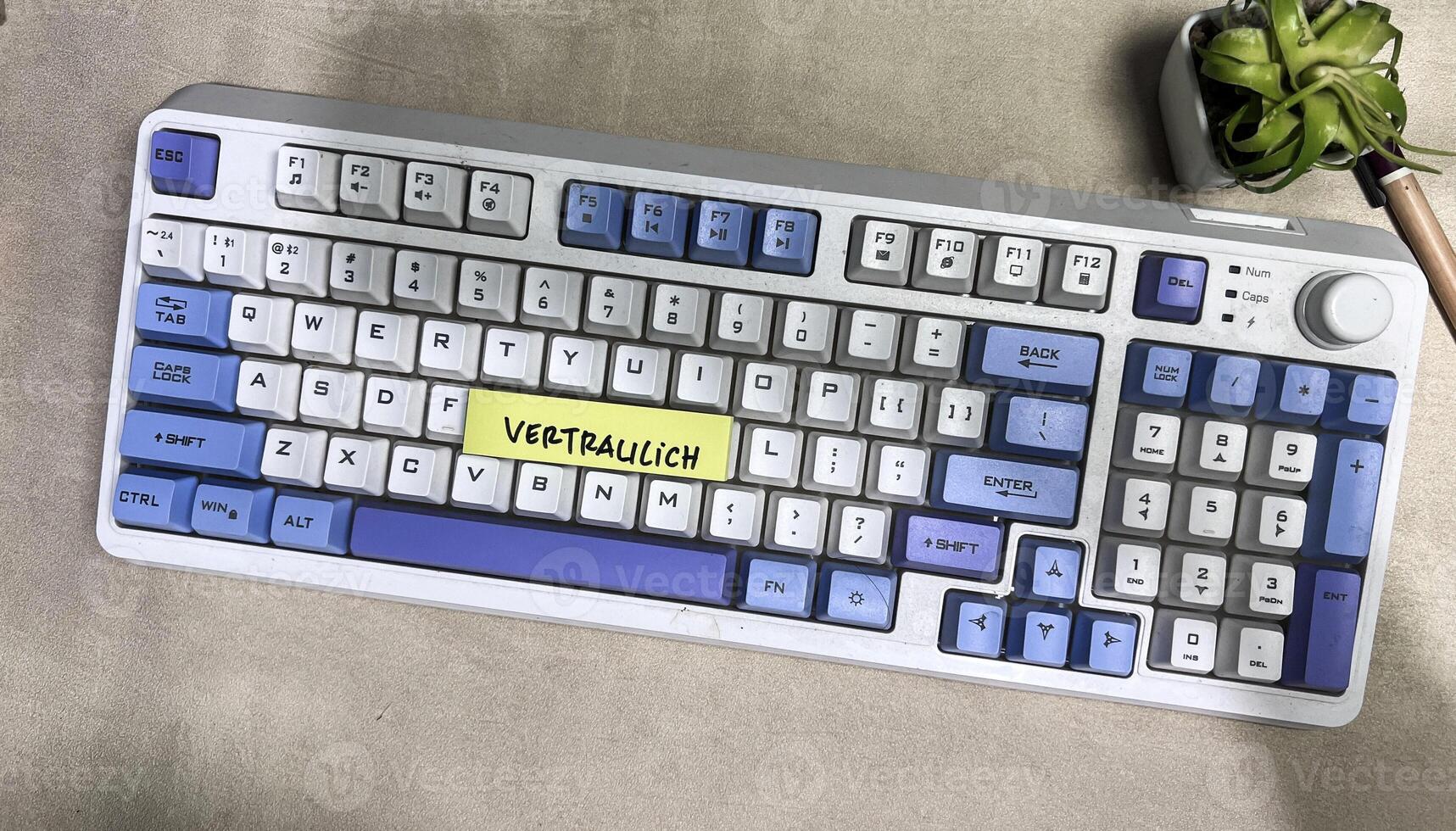 Concept of Vertraulich on German Language write on sticky notes isolated on Wooden Table. German Language it means Confidential photo