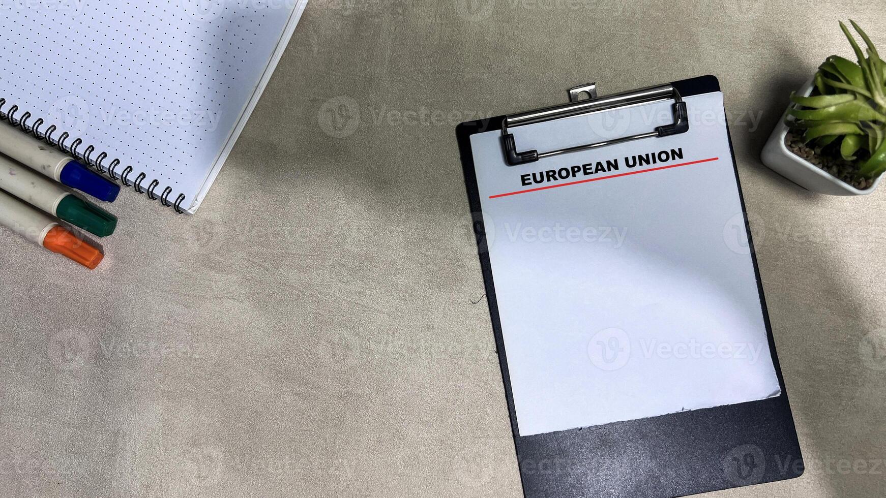 Concept of European Union write on paperwork isolated on wooden background. photo