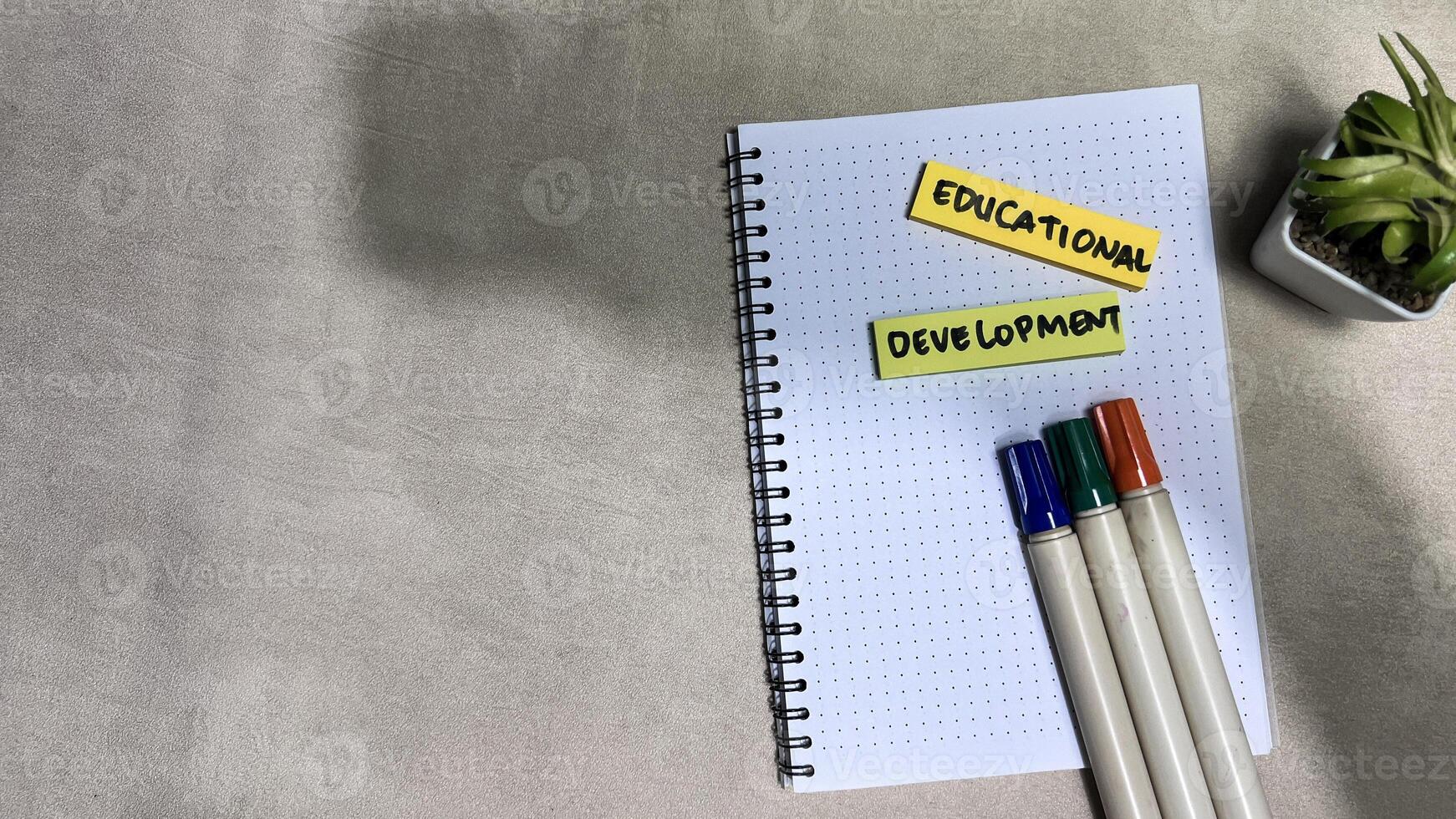 Concept of Educational Development write on sticky notes isolated on Wooden Table. photo