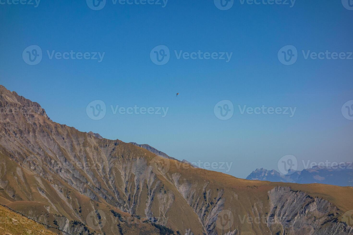 A person riding a horse on a mountain photo