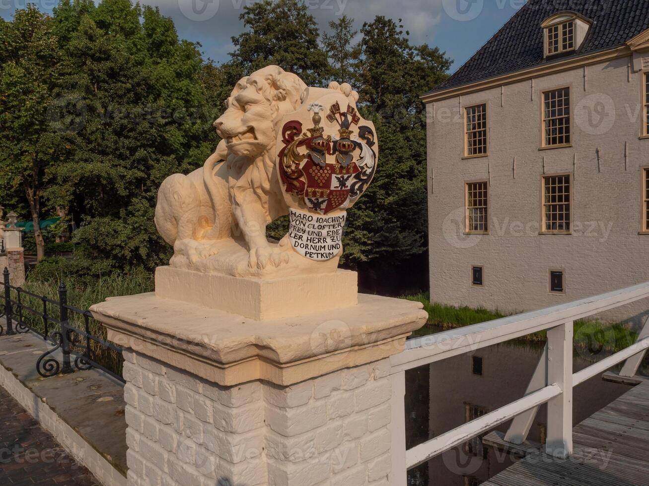 A lion statue on a bridge in front of a building photo