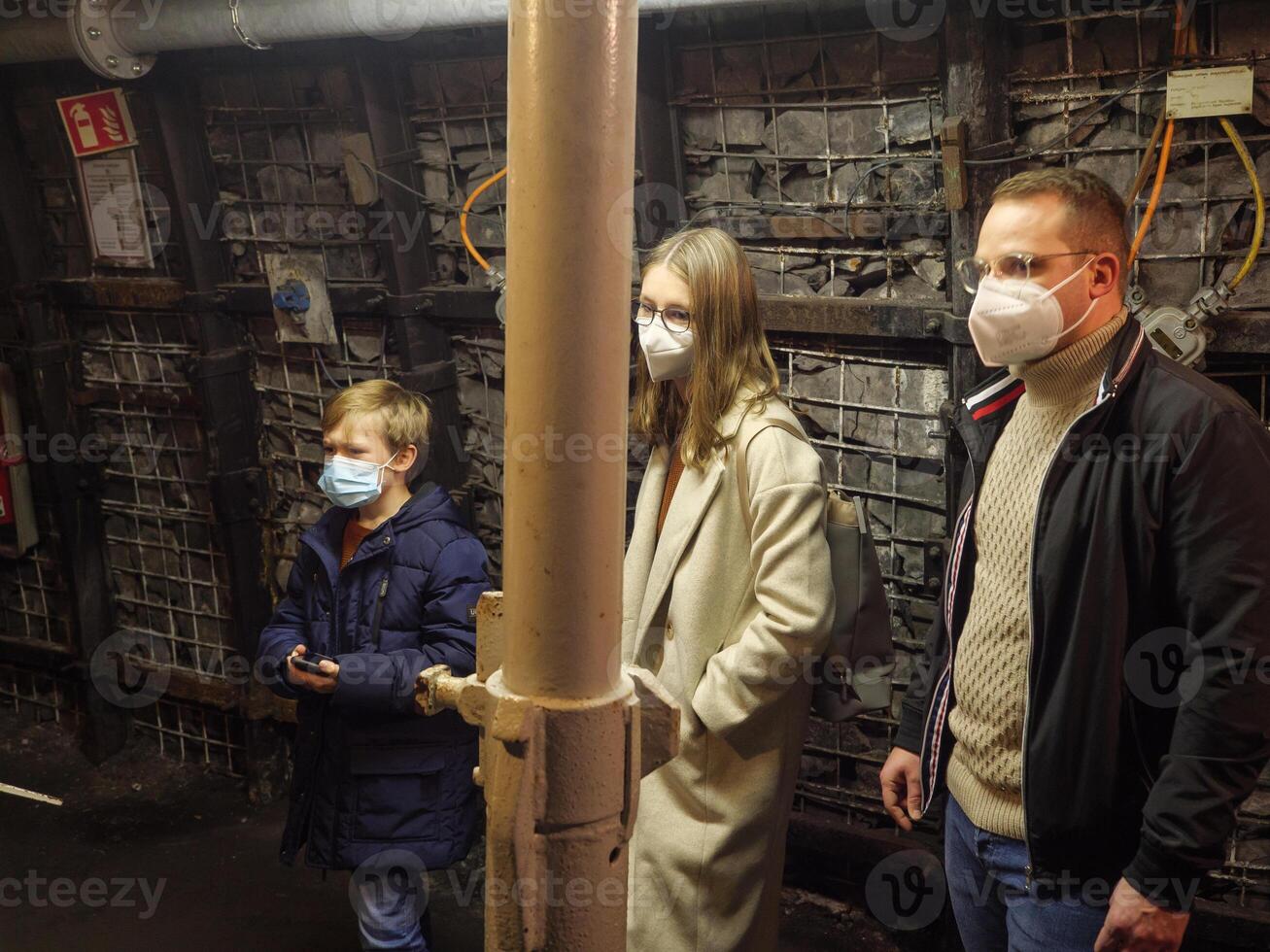 A man and two children wearing face masks photo