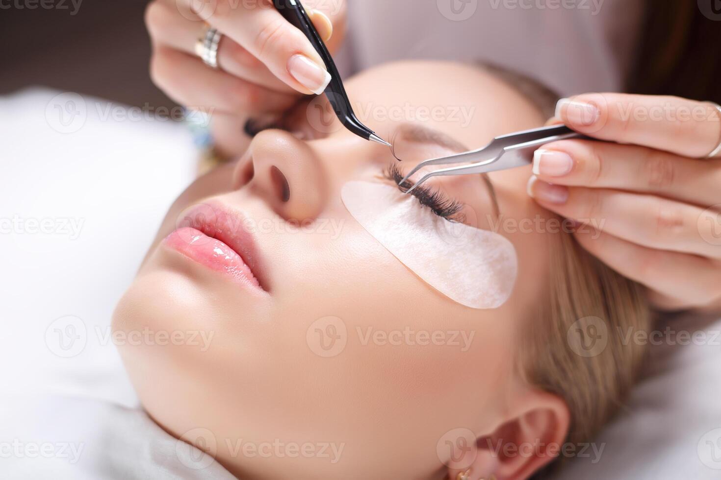 Eyelash Extension Procedure. Woman Eye with Long Eyelashes. Lashes, close up, selected focus. photo
