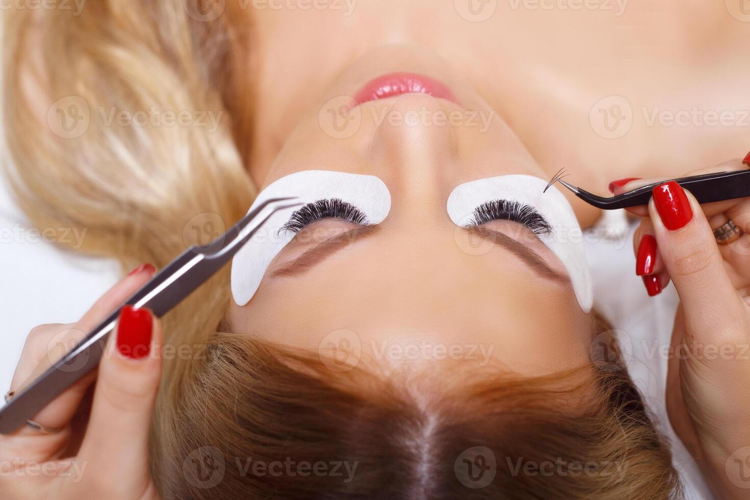 Eyelash Extension Procedure. Woman Eye with Long Eyelashes. Lashes, close up, selected focus. photo