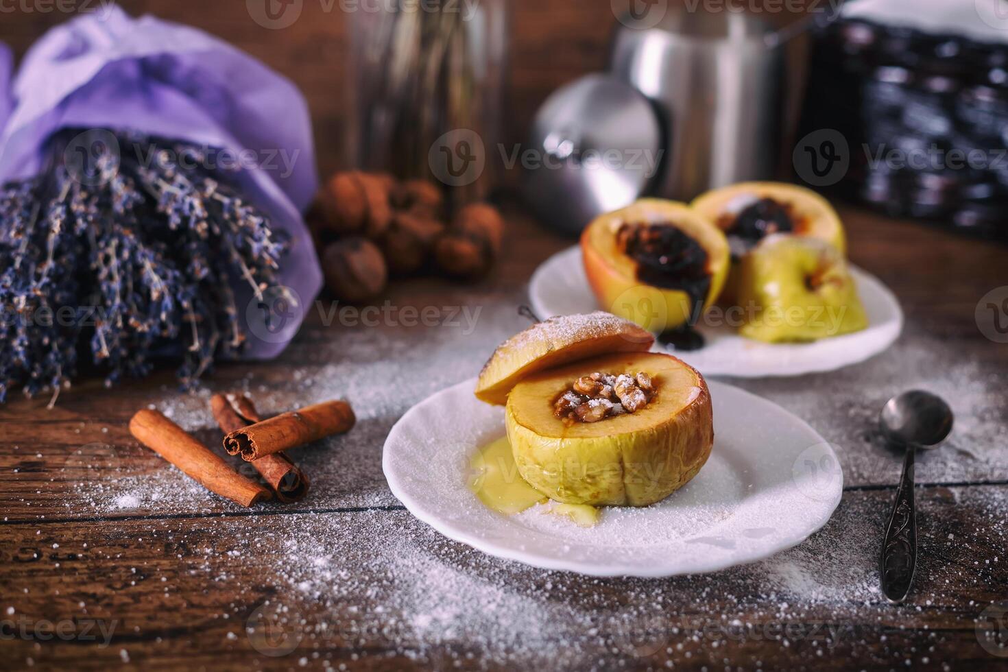 stuffed baked apple with nuts, honey and chocolate on white dessert plates, dark wooden background. Christmas sweet. healthy eating concept. photo