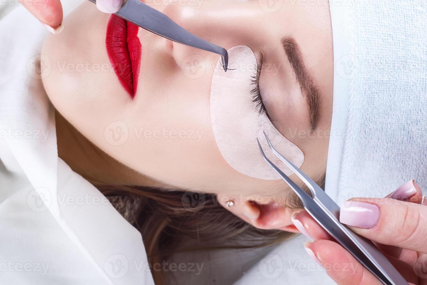 Eyelash Extension Procedure. Woman Eye with Long Eyelashes. Lashes, close up, selected focus. photo