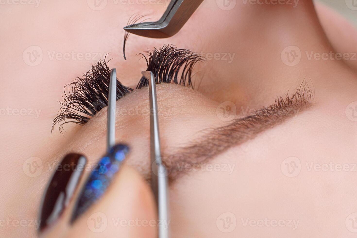 Eyelash Extension Procedure. Woman Eye with Long Eyelashes. Lashes, close up, macro, selective focus. photo
