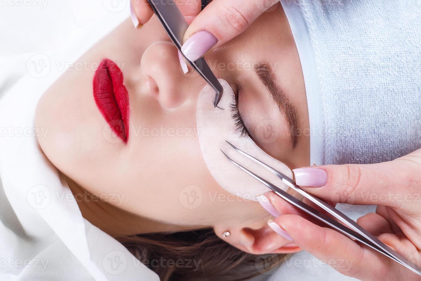 Eyelash Extension Procedure. Woman Eye with Long Eyelashes. Lashes, close up, selected focus. photo
