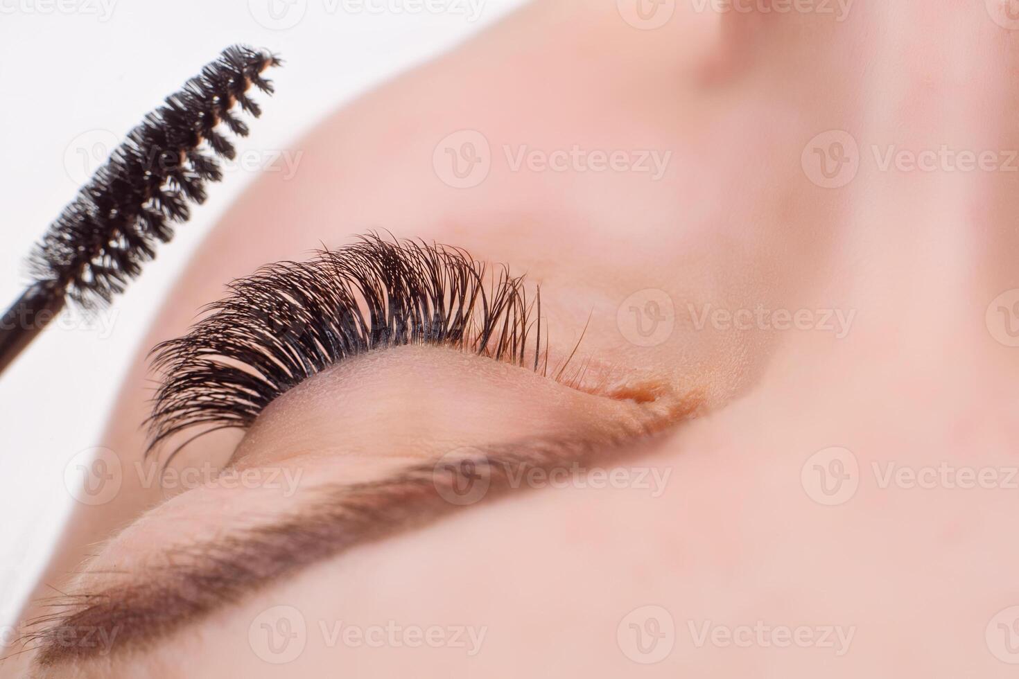 Eyelash Extension Procedure. Woman Eye with Long Eyelashes. Lashes, close up, macro, selective focus. photo
