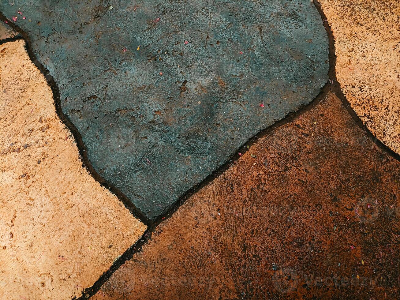 Abstract texture of stone pavement with earthy tones and dark outlines. The image showcases the natural patterns and colors, highlighting the artistic design of the surface. photo