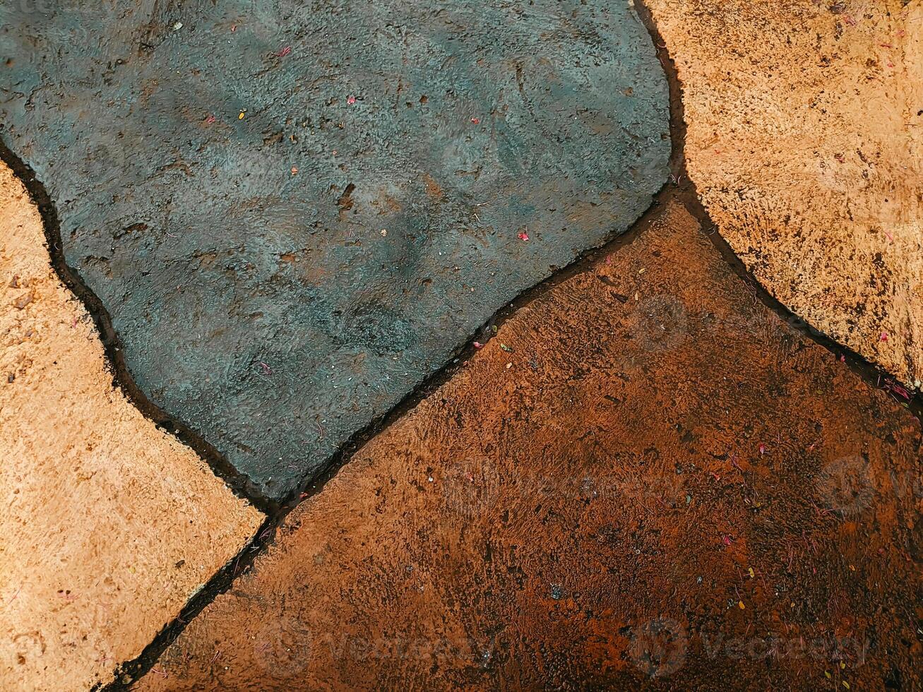 Abstract texture of stone pavement with earthy tones and dark outlines. photo