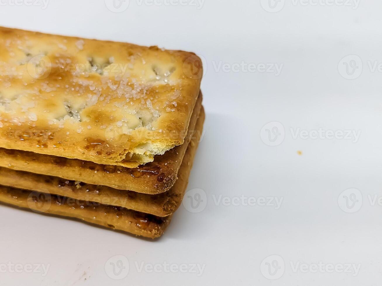 A detailed side view of stacked chocolate-filled crackers, emphasizing texture and indulgence. The fine salt crystals on the biscuit add an extra layer of flavor to this sweet treat. photo