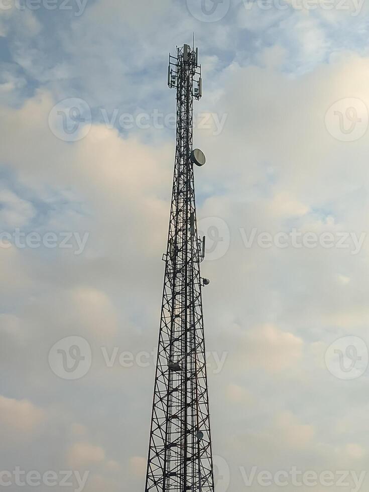 This image features a towering communication mast set against a backdrop of serene clouds, capturing the essence of technology blending seamlessly with the natural sky. photo