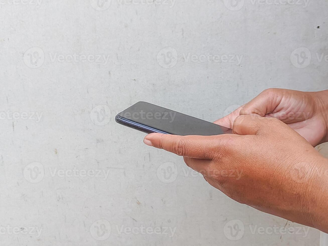 Hands engaged with a mobile phone, illustrating the seamless integration of technology into daily routines and the importance of staying connected. photo