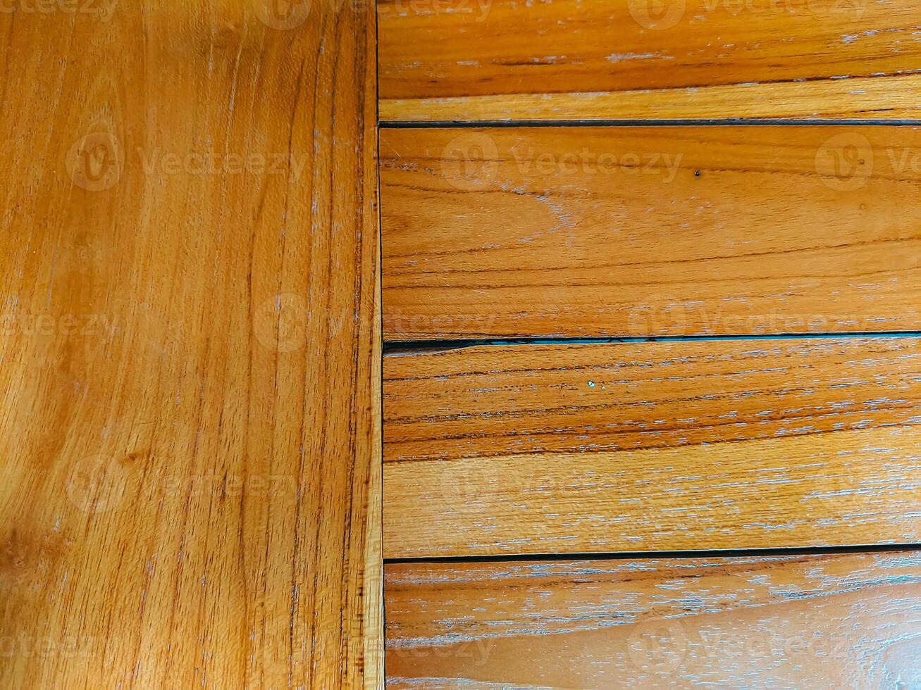 Close-up of wooden planks with rich amber hues and visible grain patterns. The mix of vertical and horizontal lines adds depth, perfect for backgrounds or nature-themed designs photo