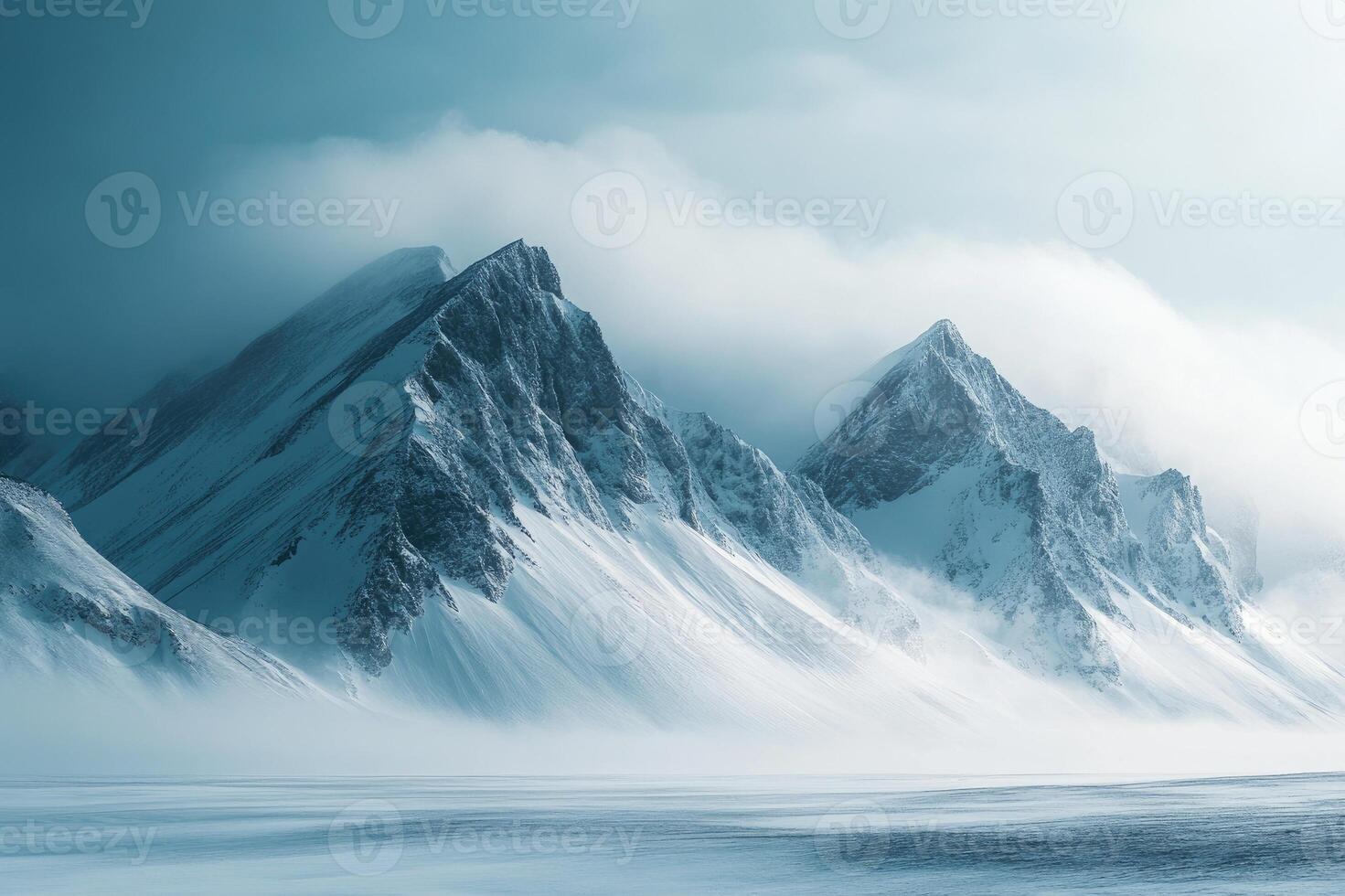 Snowy mountains rising from frozen landscape under cloudy sky photo