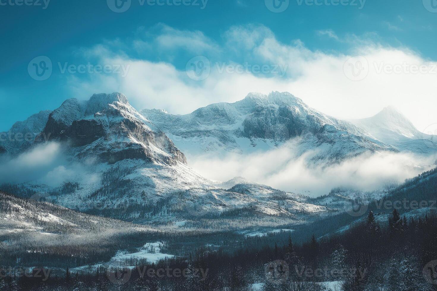 Majestic snow-capped mountain peaks rising above the clouds in a serene winter landscape photo