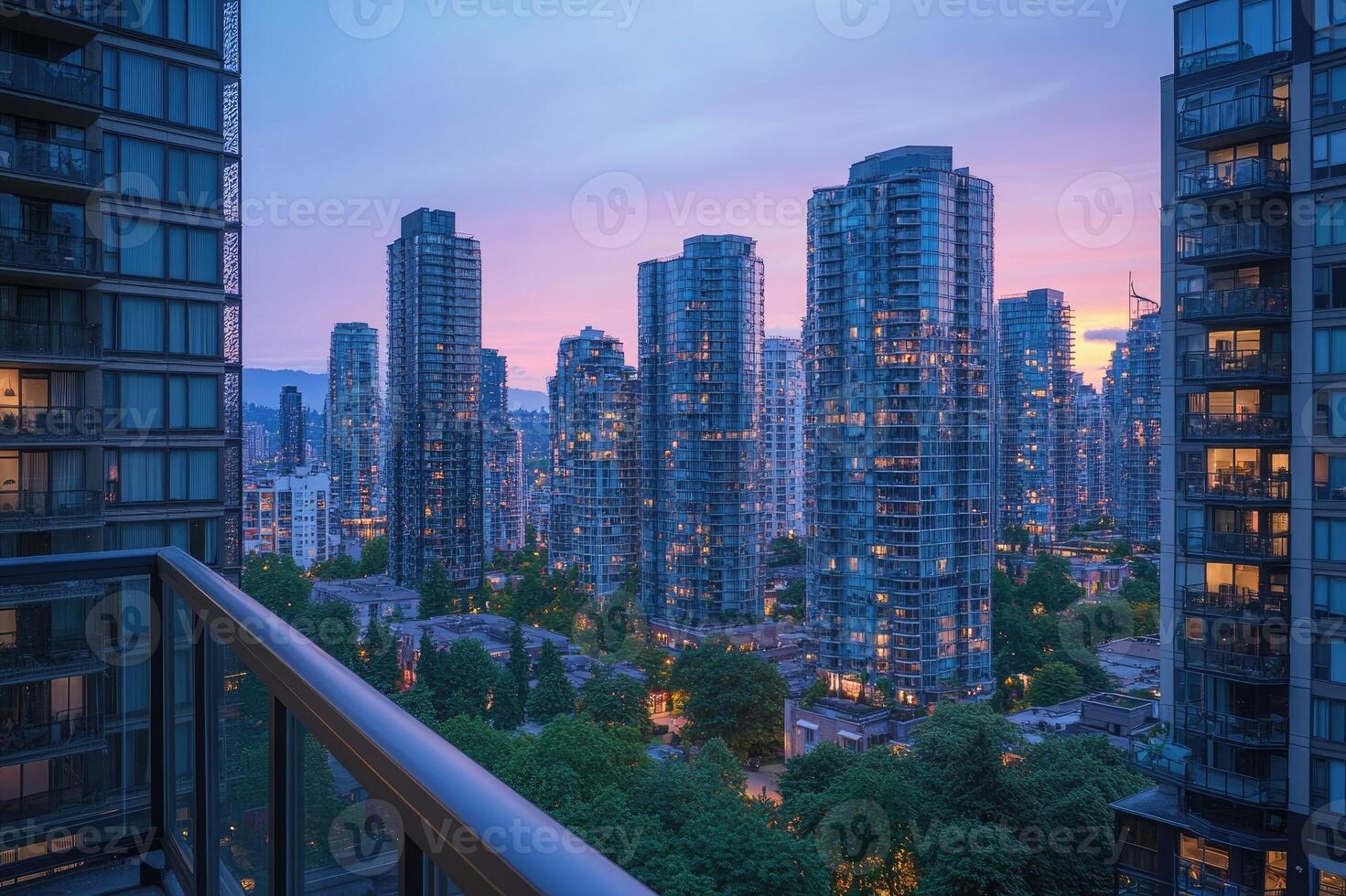 Modern cityscape of vancouver showing illuminated skyscrapers at dusk from a balcony photo