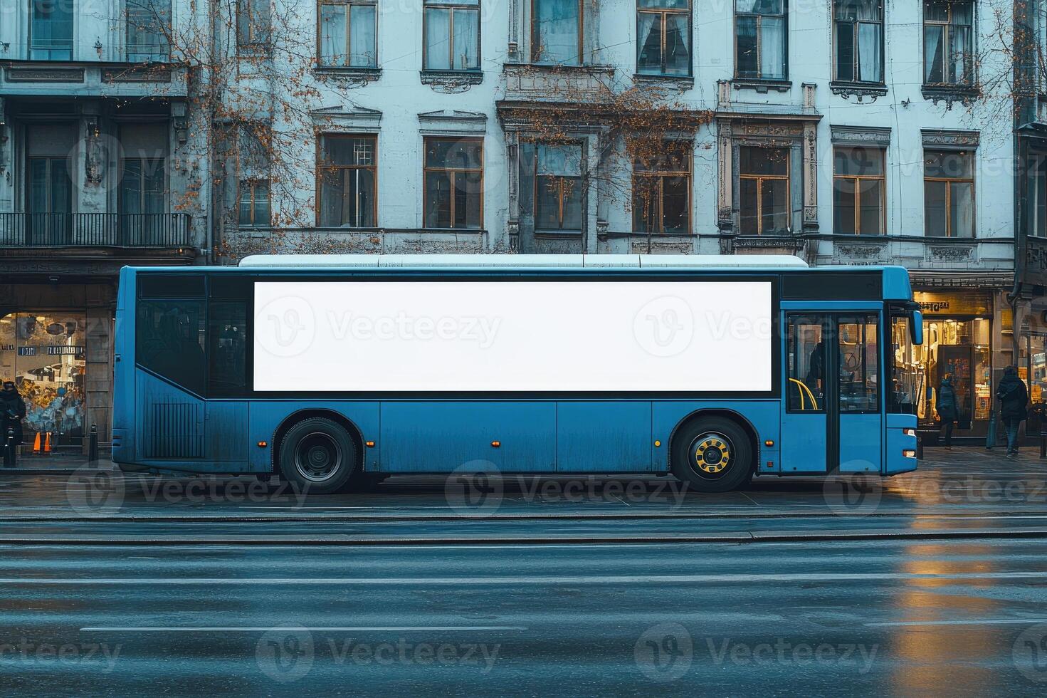 Blue bus with empty billboard driving on city street photo