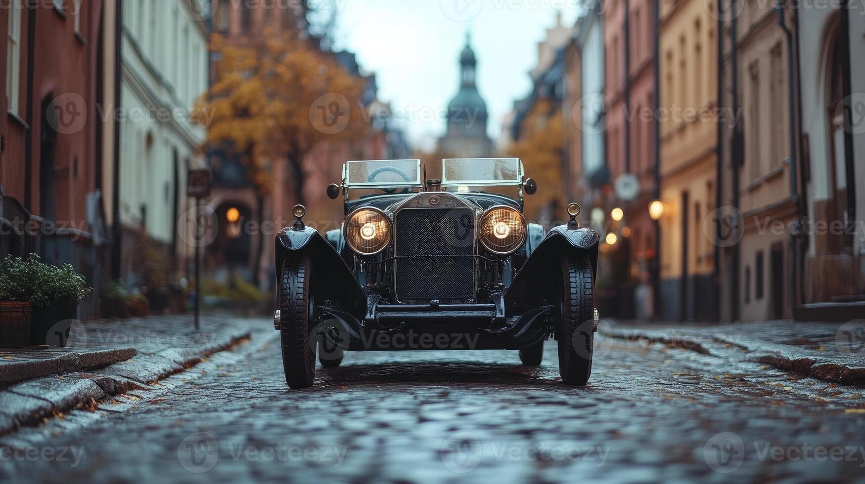Classic luxury car parked on cobblestone street in charming european old town photo