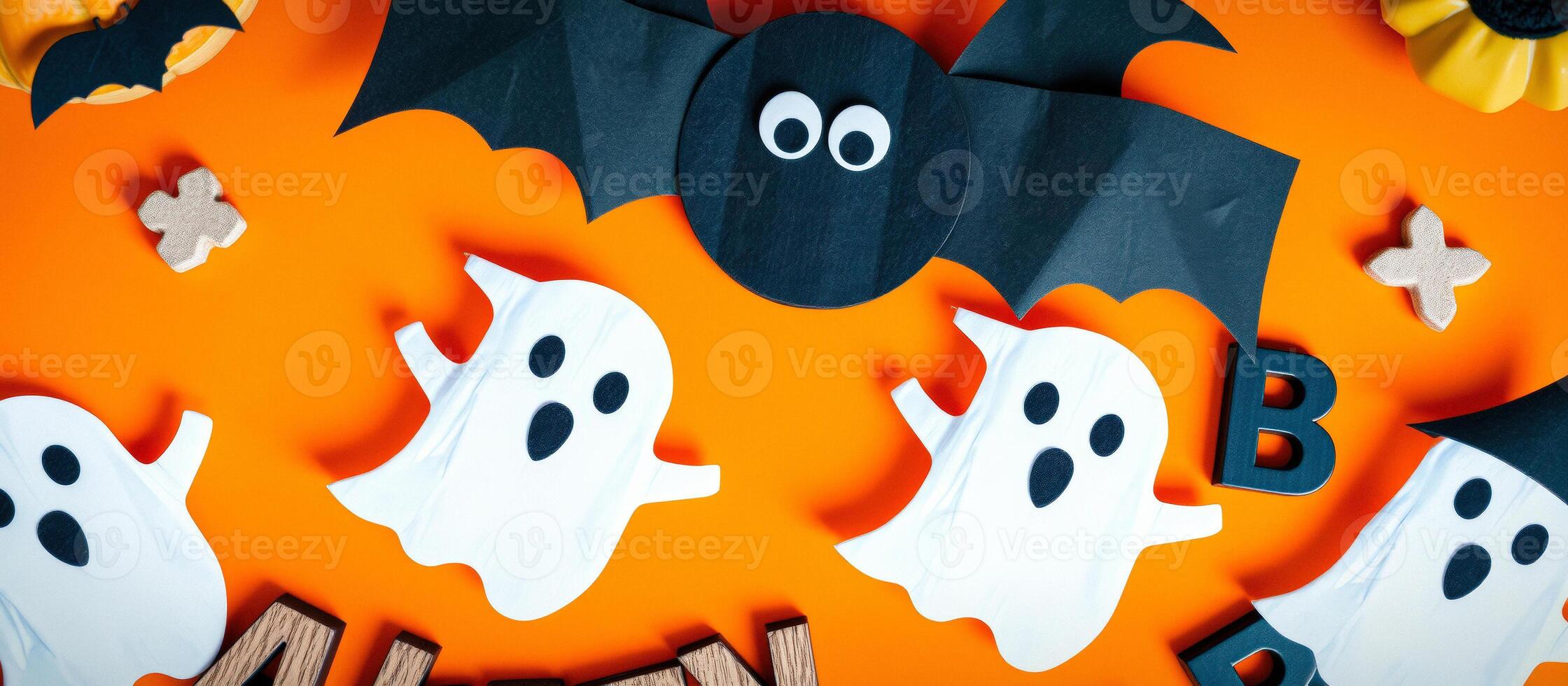 Halloween Decorations with Ghosts, Bats and Pumpkins on Orange Background photo