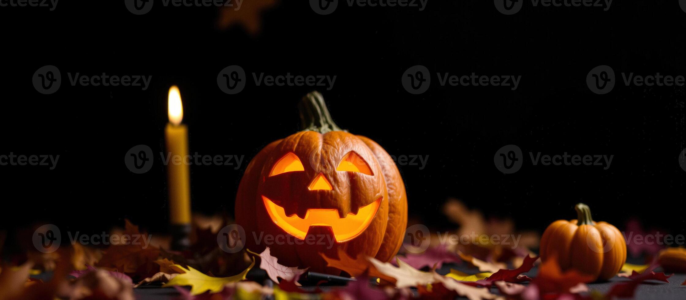 Illuminated Jack-O'-Lantern with Candlelight and Autumn Leaves photo