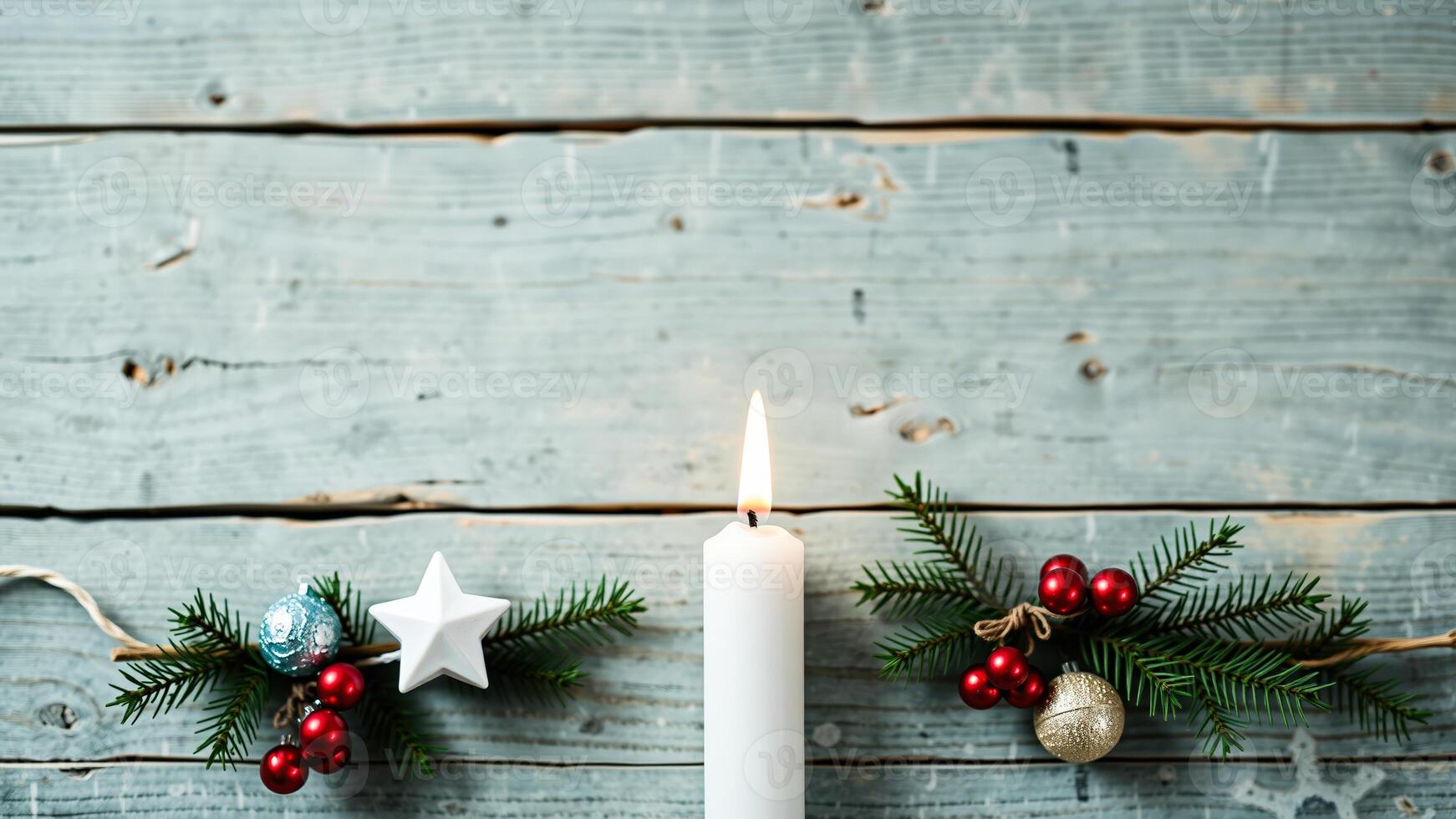 Burning Candle and Christmas Decorations on Weathered Wooden Background photo