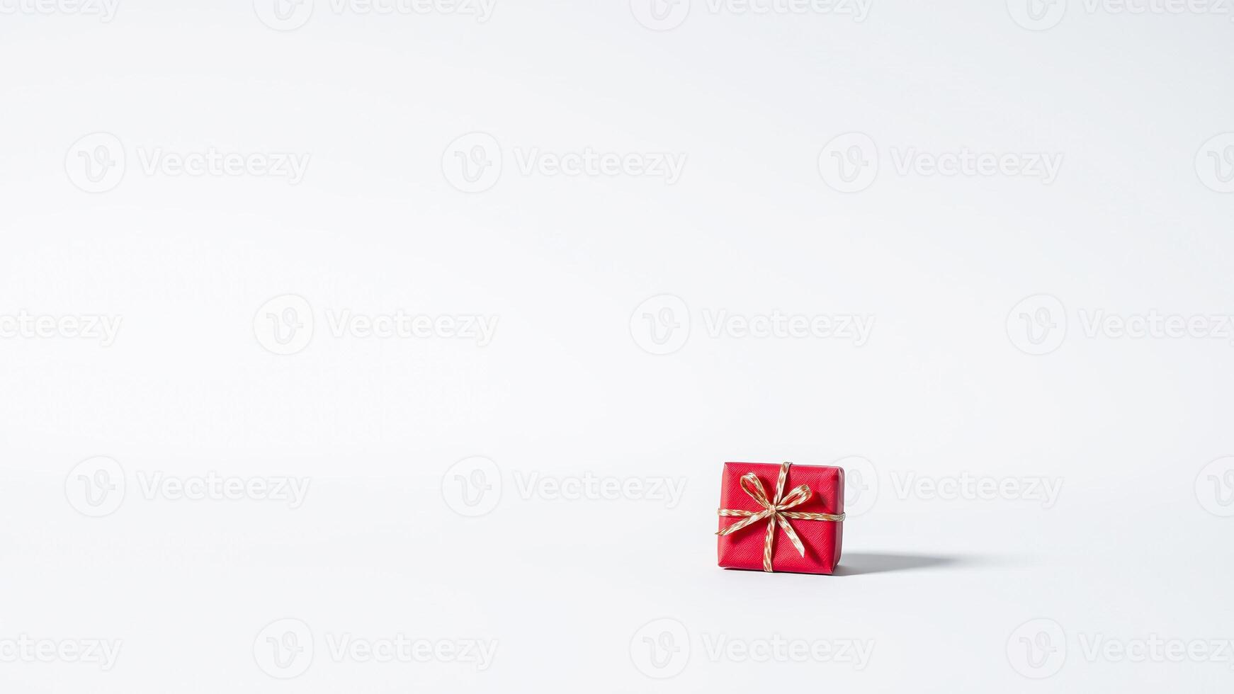 Red Gift Box with Gold Ribbon on White Background photo