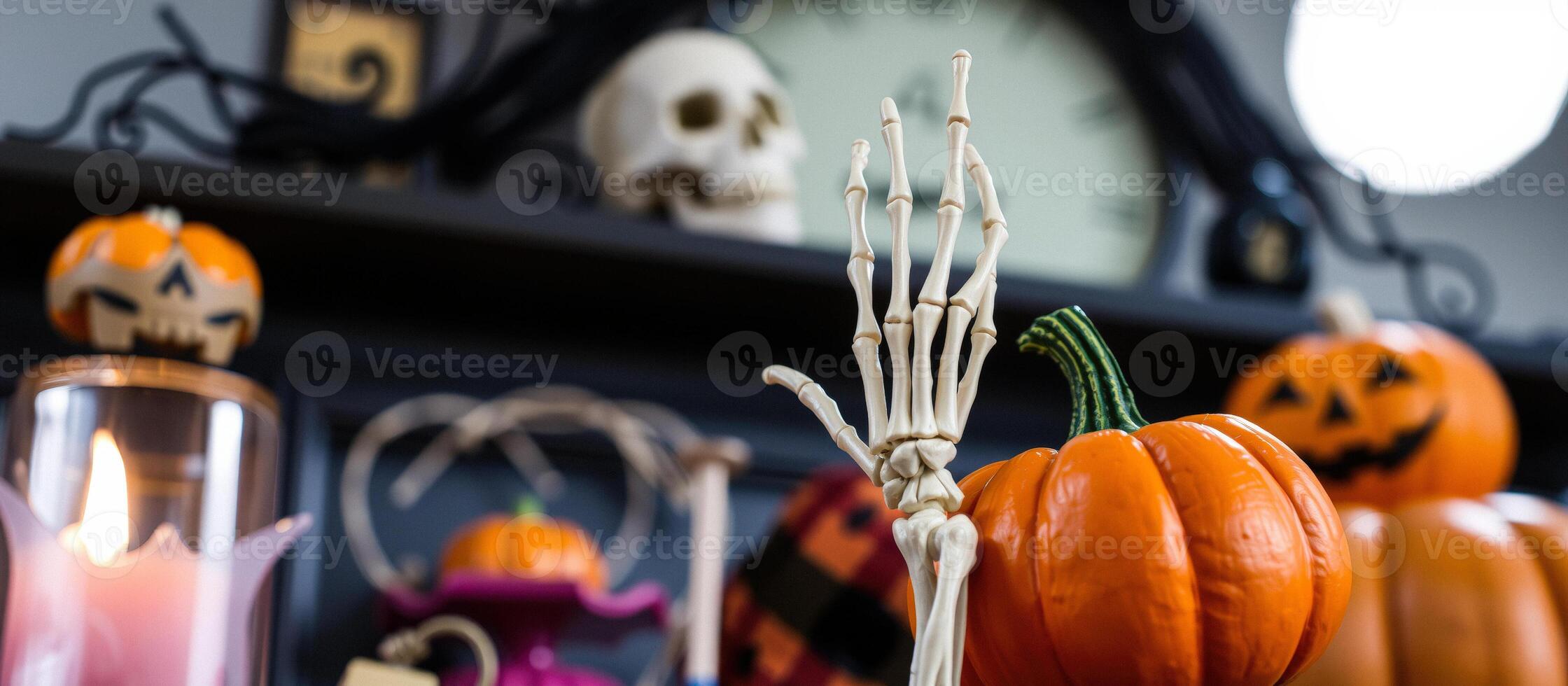 Skeleton Hand Holding a Pumpkin photo
