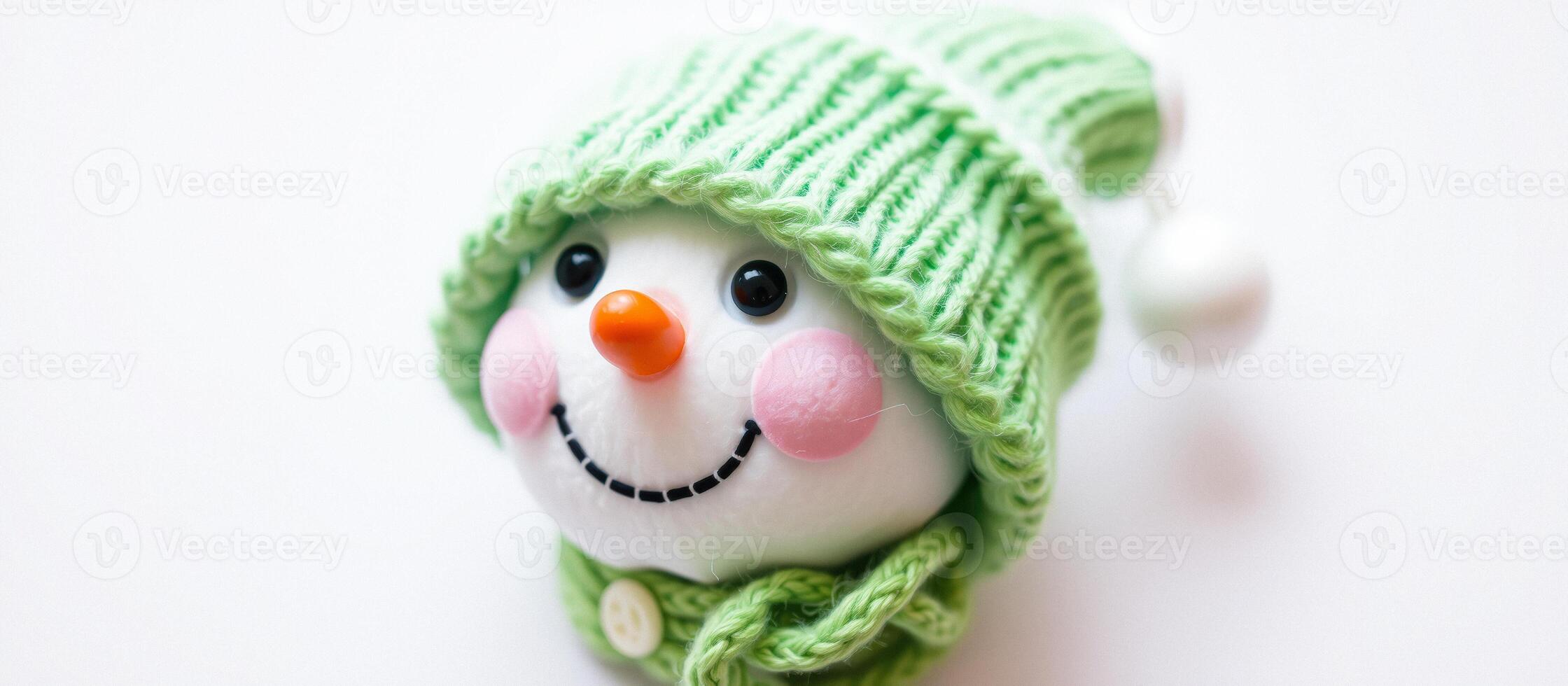 Close-up of a Snowman Ornament with a Green Hat and Scarf photo