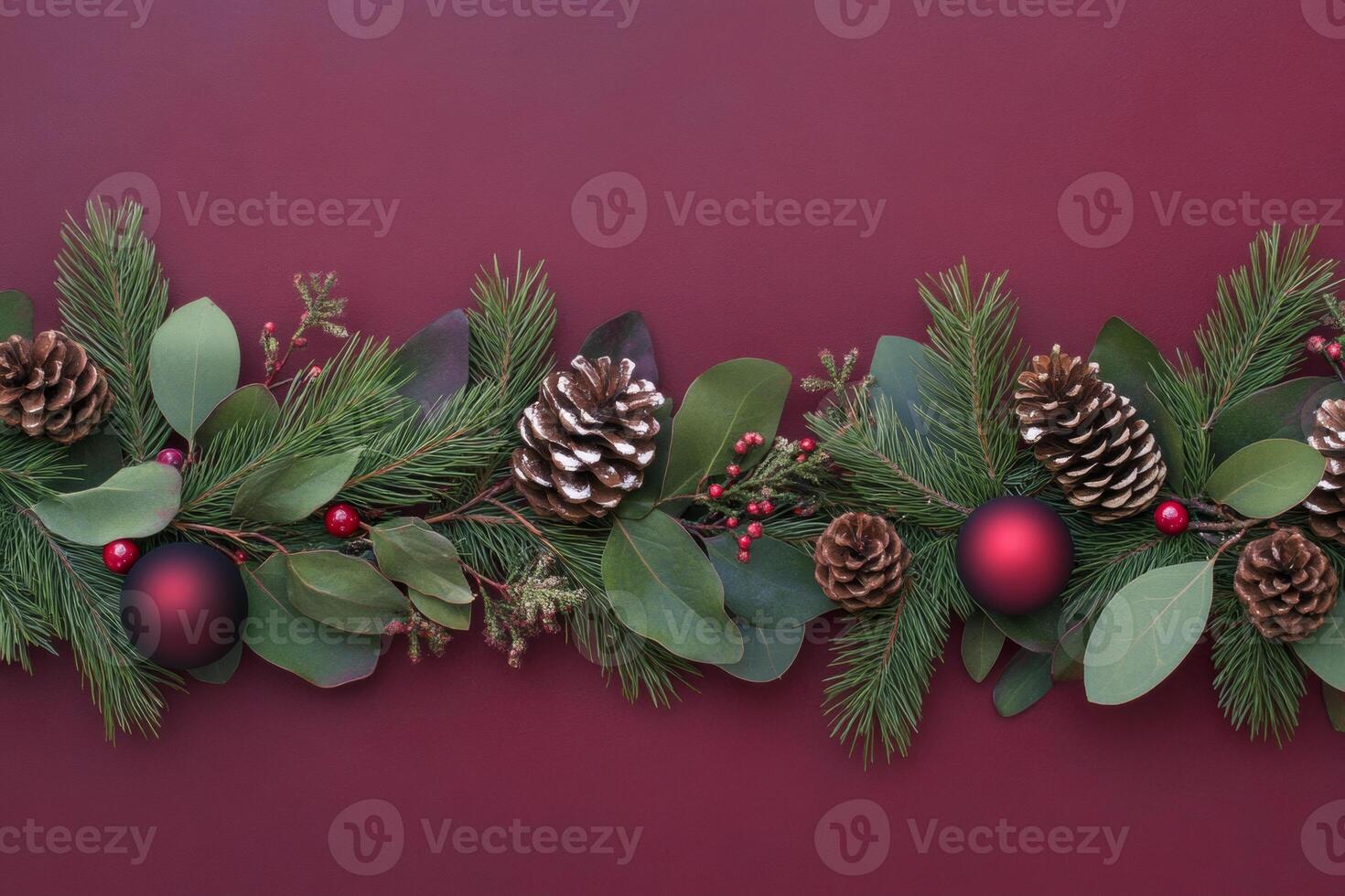 Festive Christmas decoration border with evergreen branches and red baubles on dark red background photo