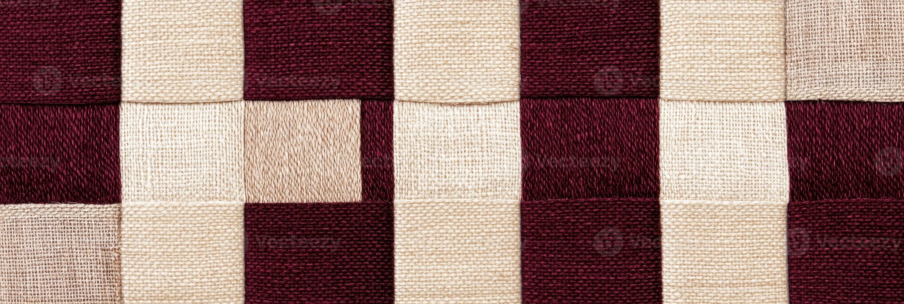 Elegant close-up of rich burgundy and beige fabric texture with warm lighting highlights detail and softness photo