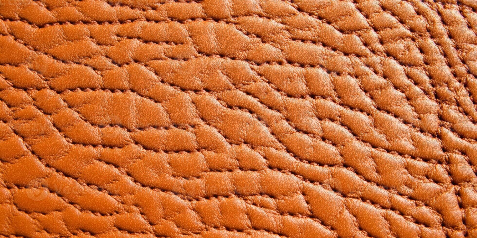 Close-up of rich brown leather texture showcasing intricate details and warm lighting for design inspiration photo