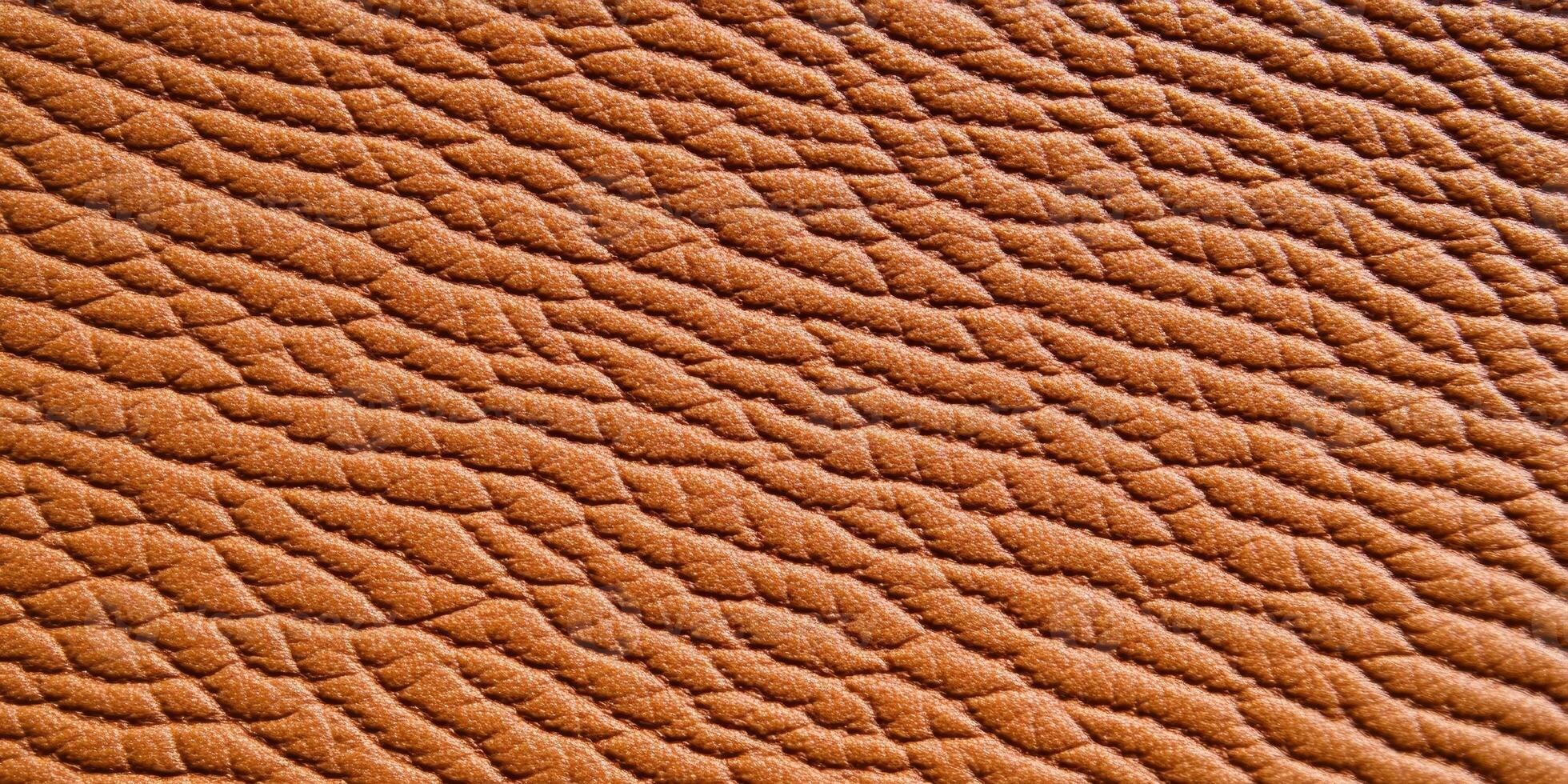 Close-up view of rich brown leather texture highlighting intricate details and warm lighting effects photo
