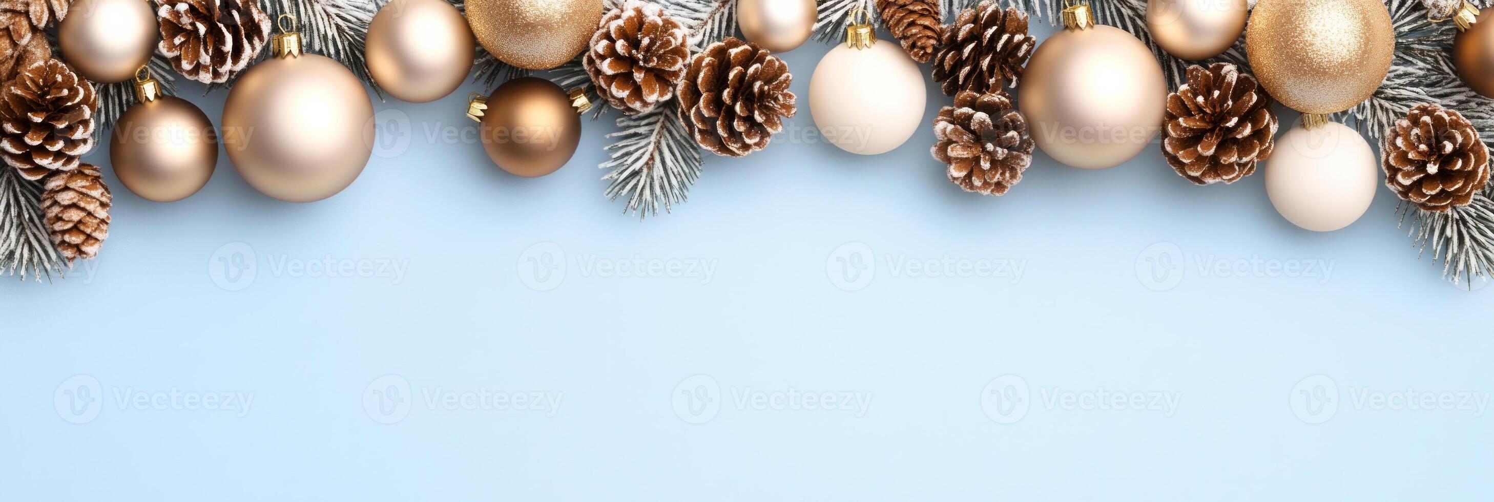 Delicate Christmas border featuring gold baubles and pinecones against a soft blue gradient background photo