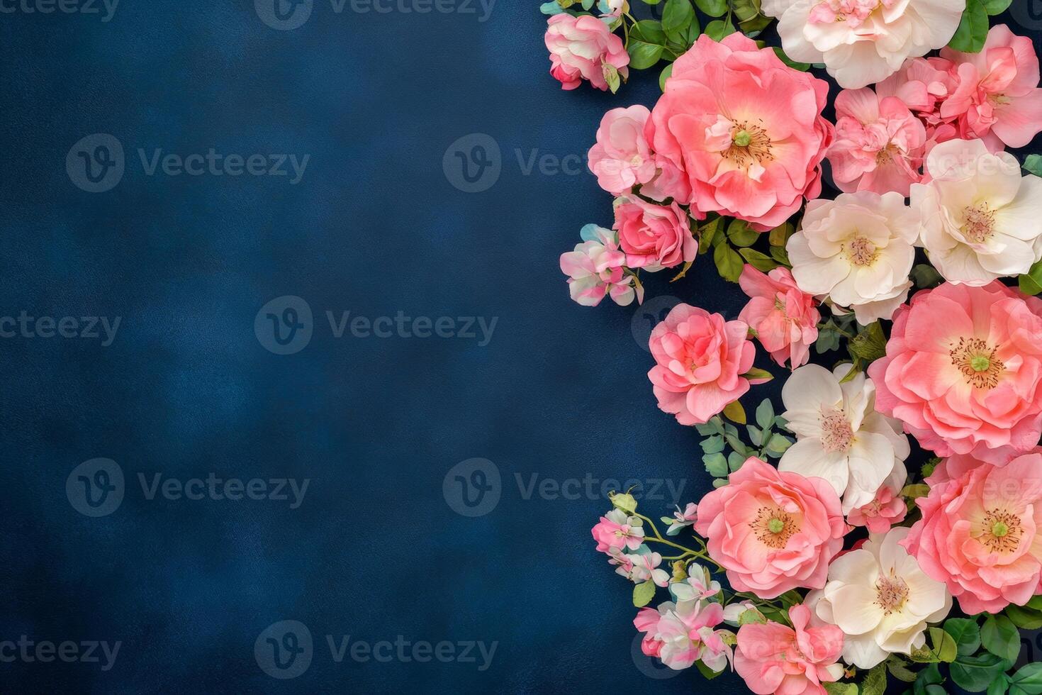 Elegant floral arrangement featuring vibrant pink roses and greenery against a dark navy background photo