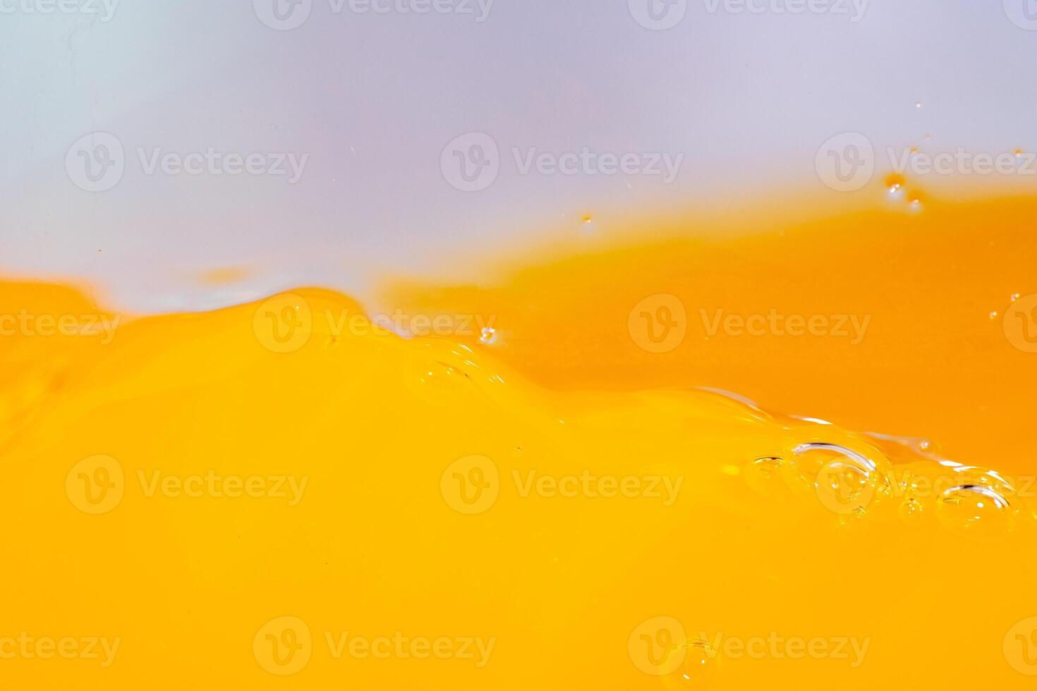Close up bright orange juice splash texture for health and nature waves, Beautiful waves curve and little bubbles smooth for garphic design and background photo