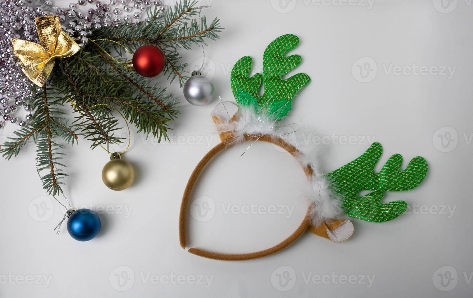 Christmas tree branches with small balls beads and a hoop with deer horns. photo