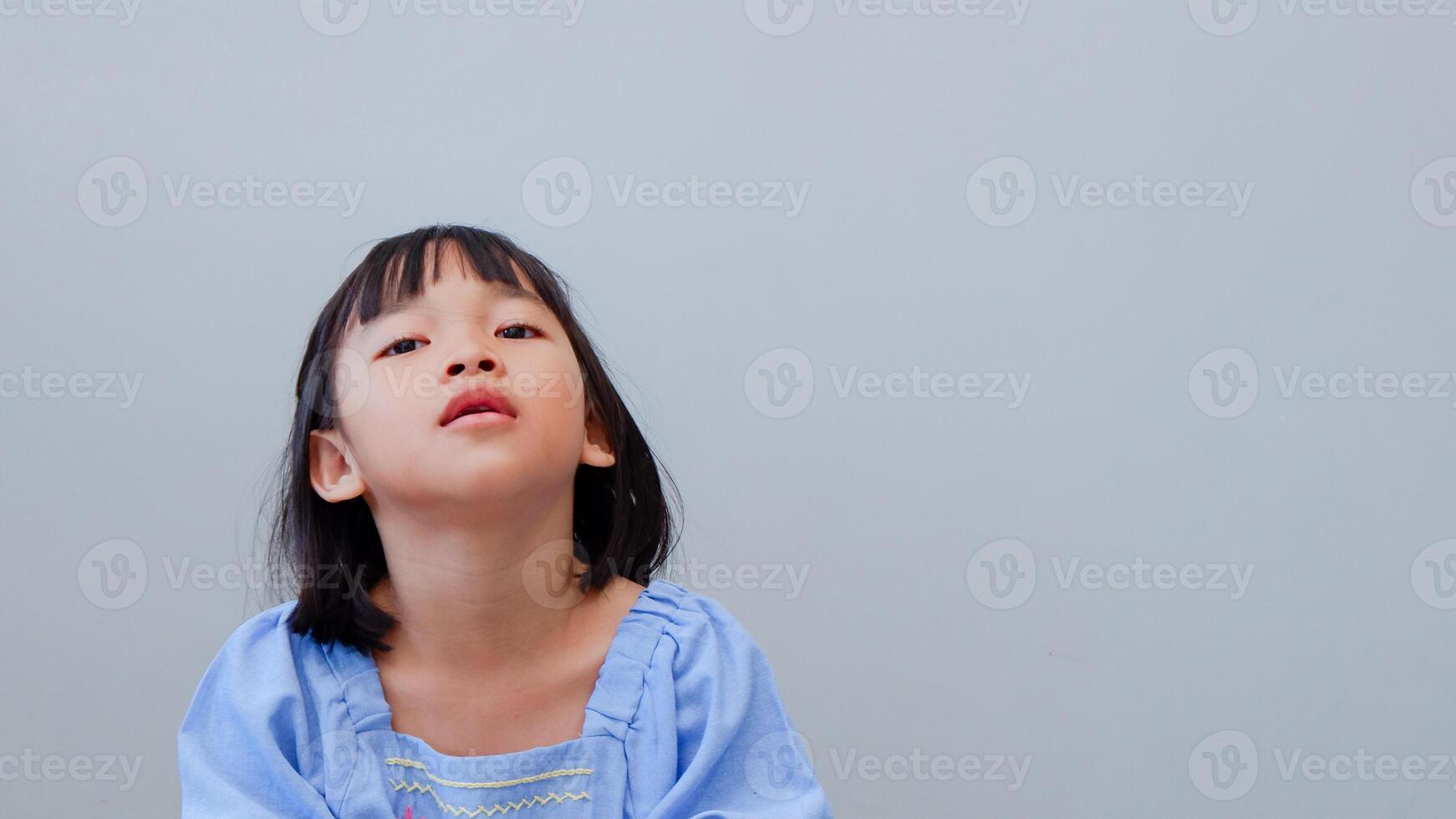 Beautiful kid girl standing over isolated grey background looking sleepy and tired, exhausted for fatigue and hangover, lazy eyes in the morning. photo