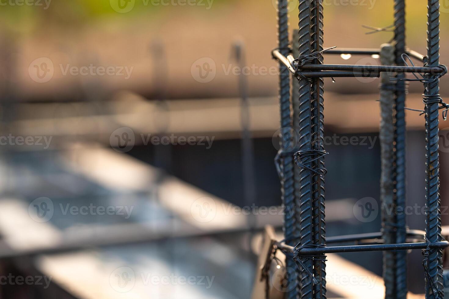 Concrete footings and reinforcing steel rods at a construction site. Groundwork for new building foundation. Reinforcement steelwork providing strength and stability for long term structural integrity photo