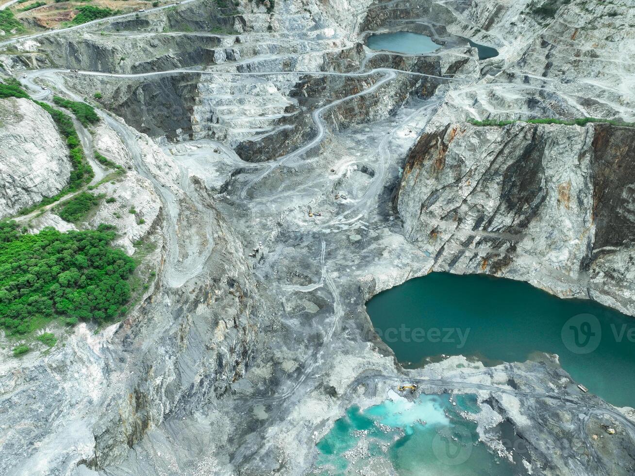 Open pit mine industry. Limestone quarry with backhoe and truck in operation. Heavy machinery in mining industry and construction material supply. Landscape of resource extraction in a industrial site photo